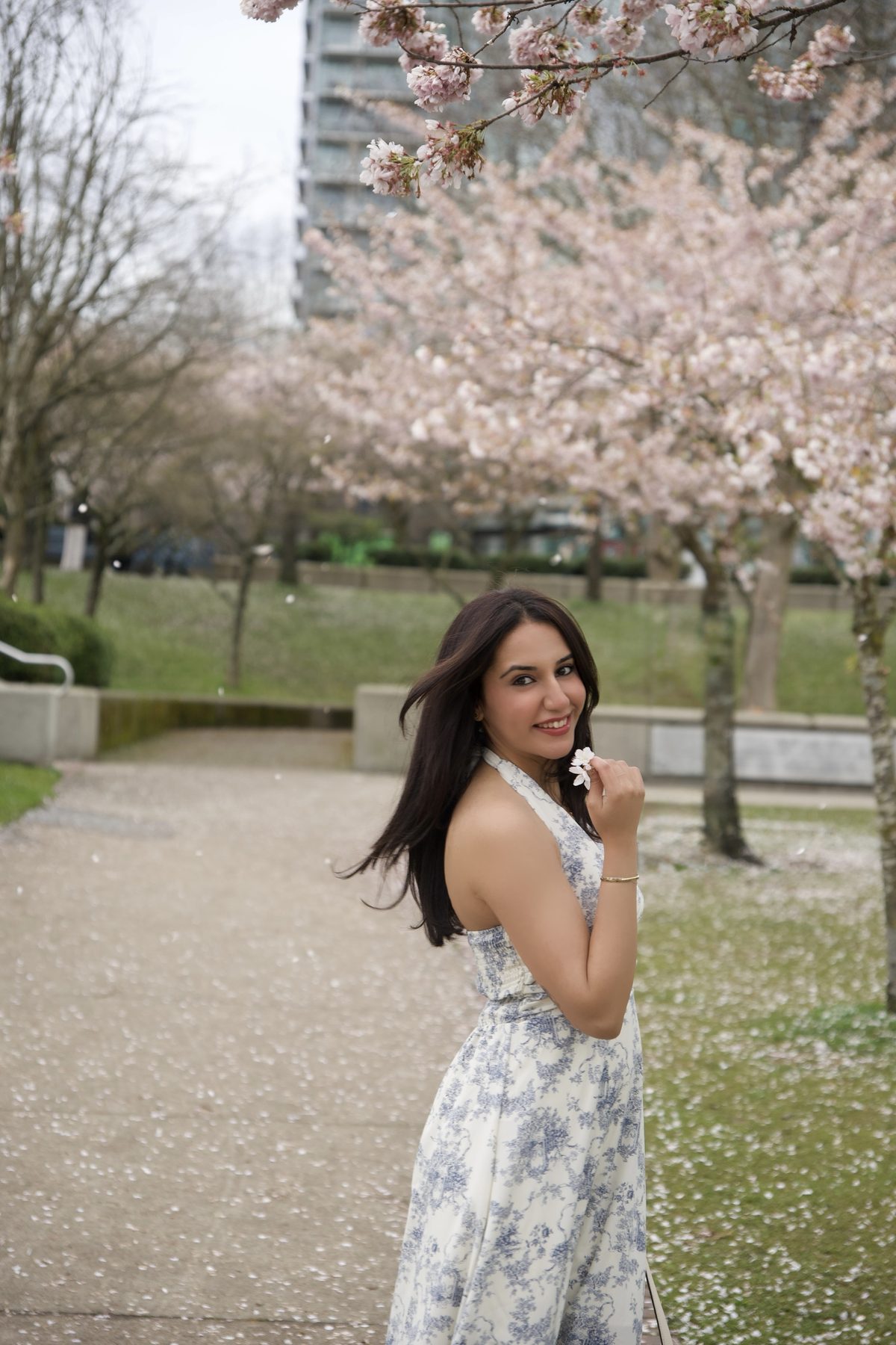 Simran outdoors under cherry blossom in Vancouver.
